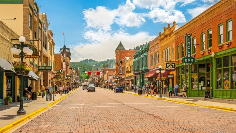 Historic Old West 19th century buildings with saloons, shops and cafes along the brick paved Main Street of Deadwood, in the Black Hills of South Dakota.