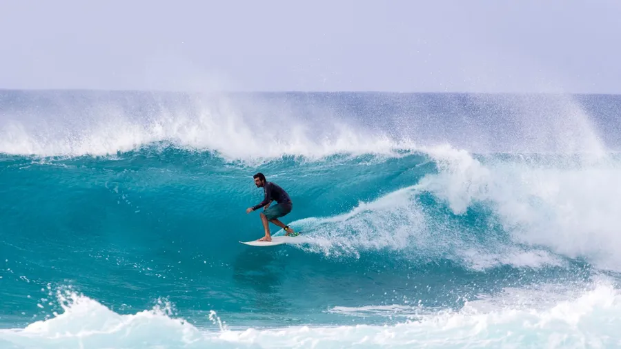 A surfer riding barrels of the Banzai Pipeline, a very popular pro-surf spot at the Northshore region of Oahu.