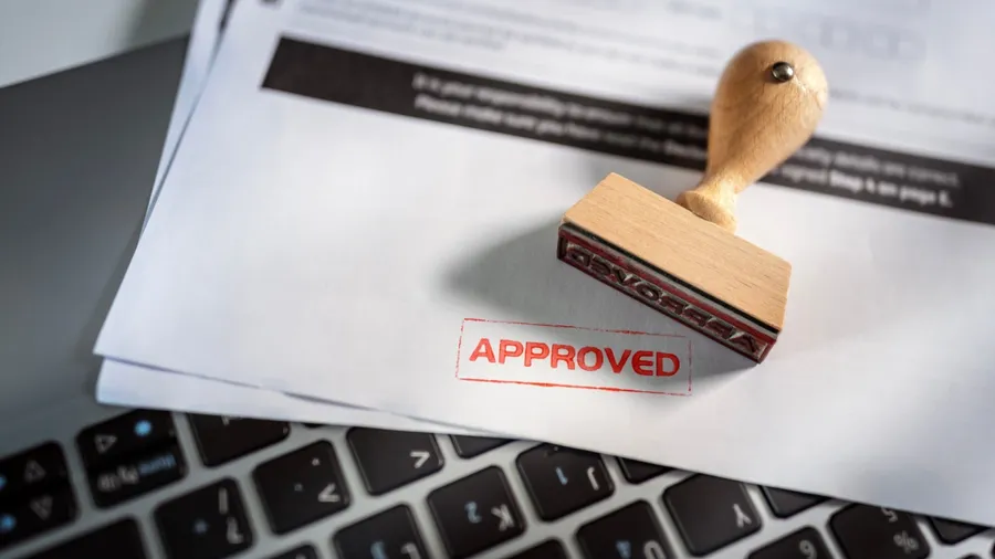 Approved document with a stamp on top of paperwork.