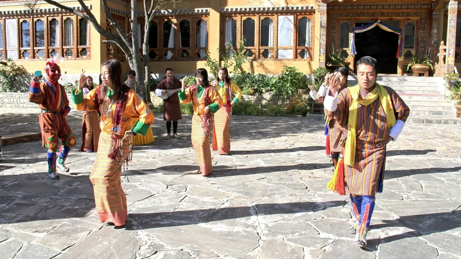 PARO, BHUTAN - November10, 2012 : Unidentified young dancers in traditional Bhutanese dress performs traditional dance. Paro, Bhutan