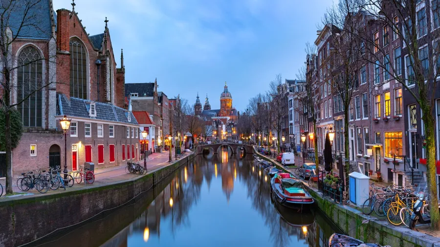 Panorama of canal in De Wallen, famous red-light district in the twilight, Amsterdam, Holland, Netherlands.