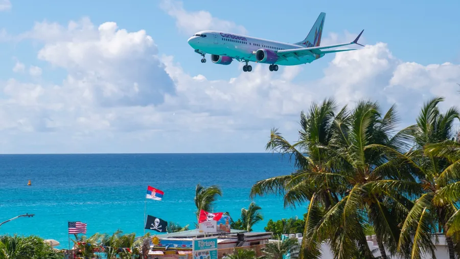 ST. MAARTEN - NOV. 28, 2023: Caribbean Airlines Boeing 737 Max 8 9Y-GUY flying over Maho Beach before landing on Princess Juliana International Airport SXM on Sint Maarten, Dutch Caribbean.
