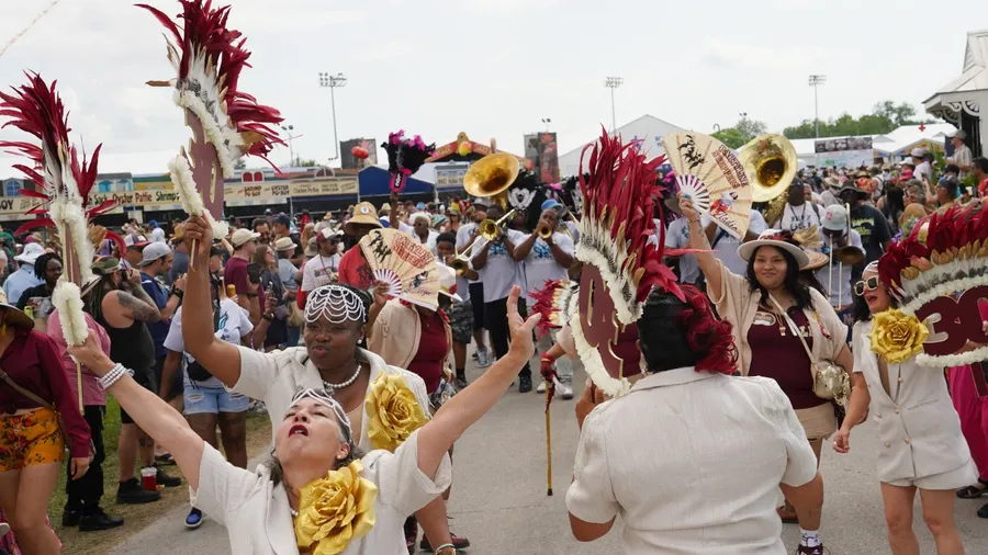 New Orleans, Louisiana - April 25, 2025: A New Orleans Social Aid and Pleasure Club marches at the 2025 New Orleans Jazz and Heritage Festival.