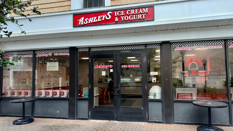 Madison, Connecticut, USA - August 7, 2023: Exterior of Ashley's Ice Cream and Yogurt Shop. Taken just after a rainstorm on a summer day. Local business chain.