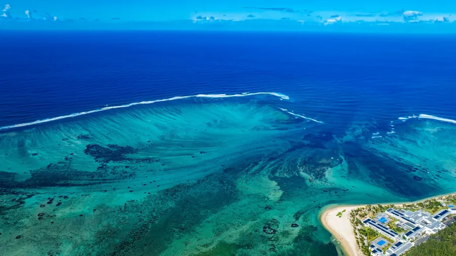 Aerial view of Mauritius island and Le Morne Brabant mountain with beautiful blue lagoon and underwater waterfall illusion background