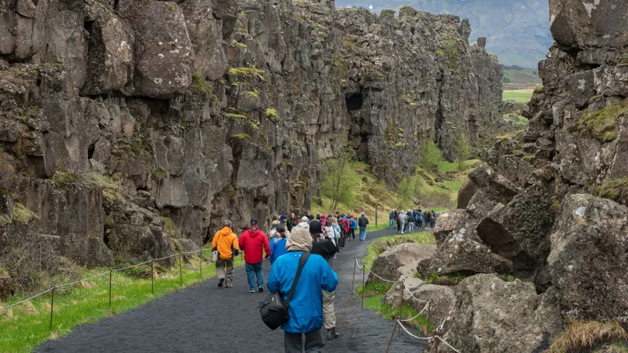 THINGVELLIR, ICELAND - MAY 20, 2019: Crowd of tourists visiting Thingvellir National Park a site of historical, cultural, and geological significance