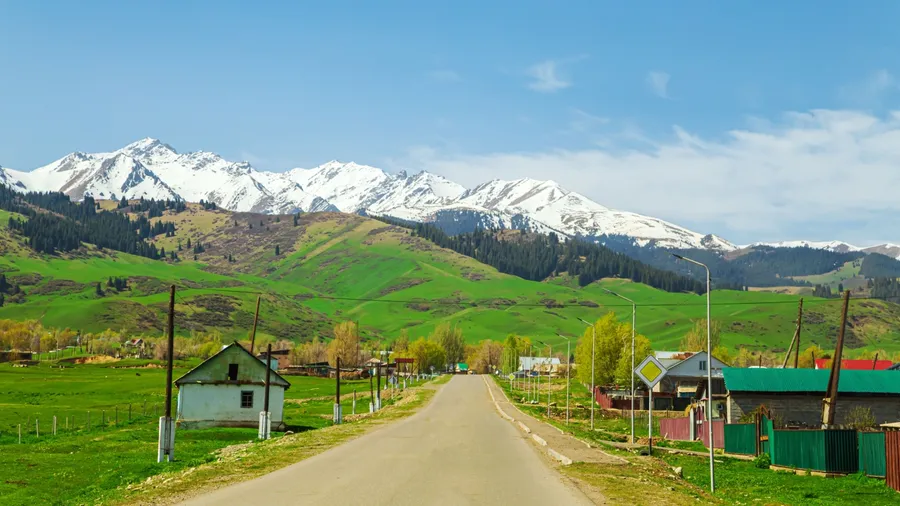 Highway in the mountains of the Trans-Ili Alatau ridge. Village and nature of Central Asia. Almaty district, Kazakhstan - May 5, 2024.