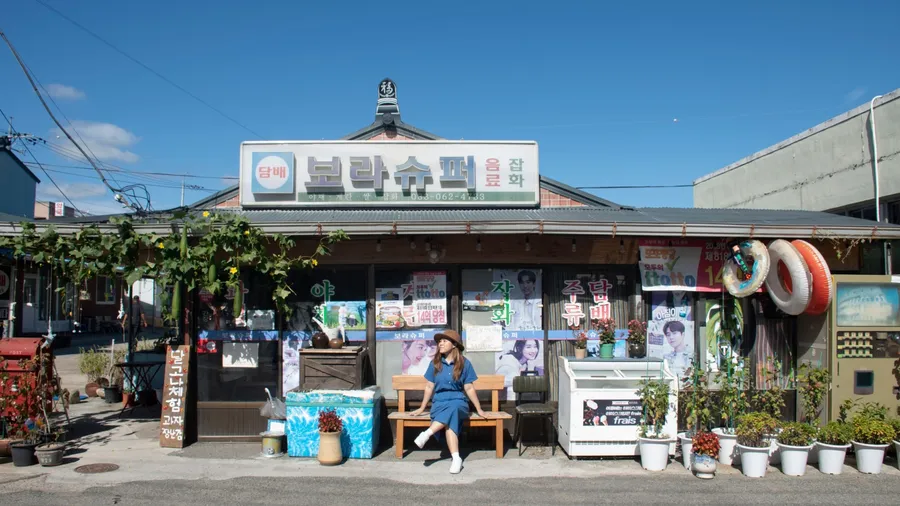 POHANG,SOUTH KOREA,OCTOBER 20, 2022: Woman traveller is sightseeing at Grocery Store from Korean Series "Hometown Cha-Cha-Cha.