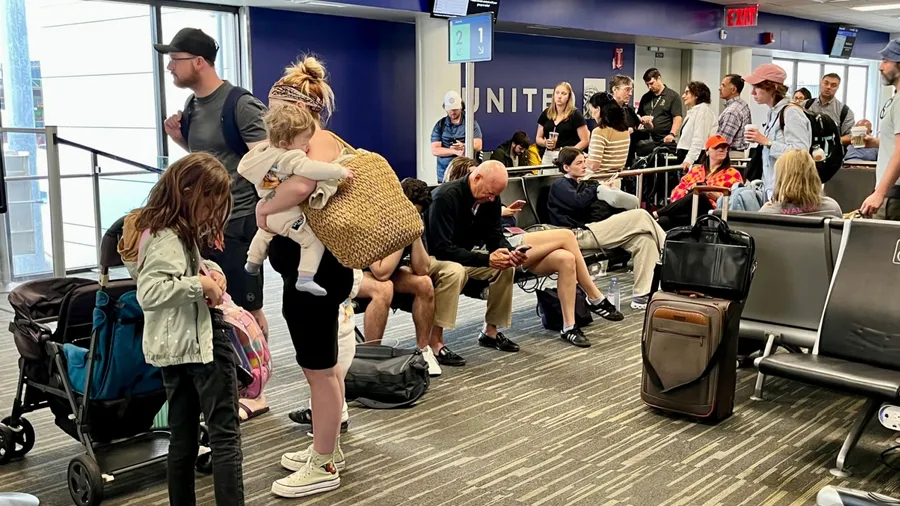 BOSTON - AUGUST 17 2025: Passengers Line Up to Board a United Airlines Flight During the Busy Summer Travel Season in August 2025 in Boston.