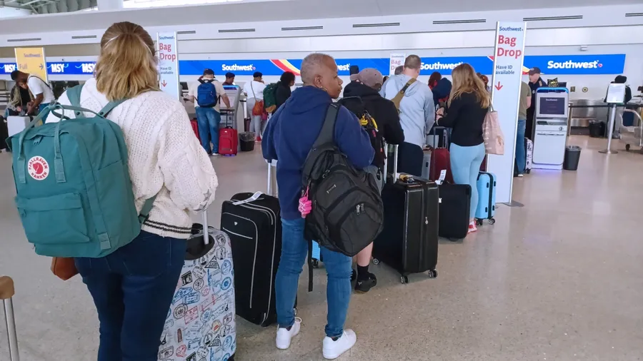 New Orleans - December 31, 2022: Passengers at Louis Armstrong Airport wait in line to check bags at the Southwest ticket counter