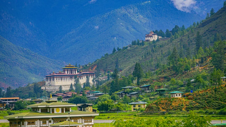 A beautiful photo of Bhutan's only international airport at Paro with the monumental Rinpung Dzong and Ta Dzong (watch tower) in the background