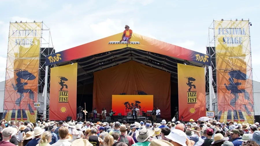 New Orleans, LA United States - April 30, 2022: Crowds at the 2022 New Orleans Jazz and Heritage Festival on the "Festival Stage" dance to funk legend Big Sam's Funky Nation.