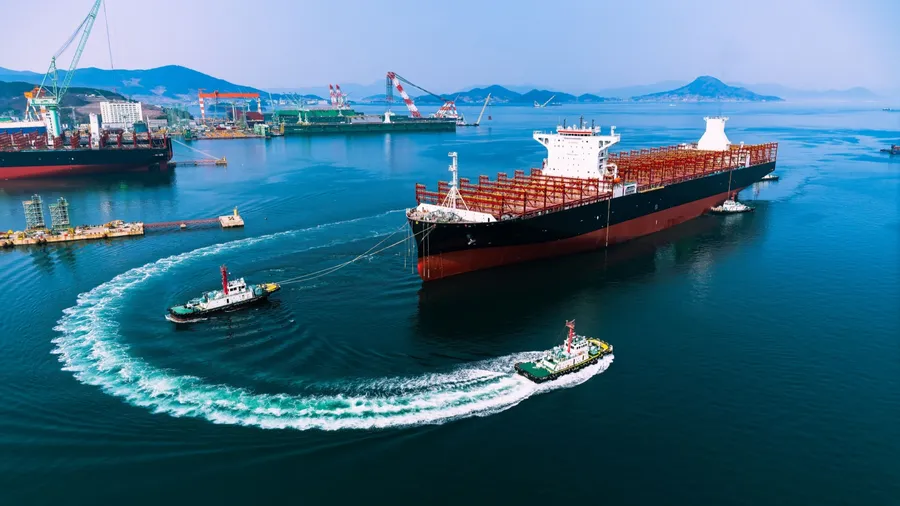 Container ship during port operations with tugs