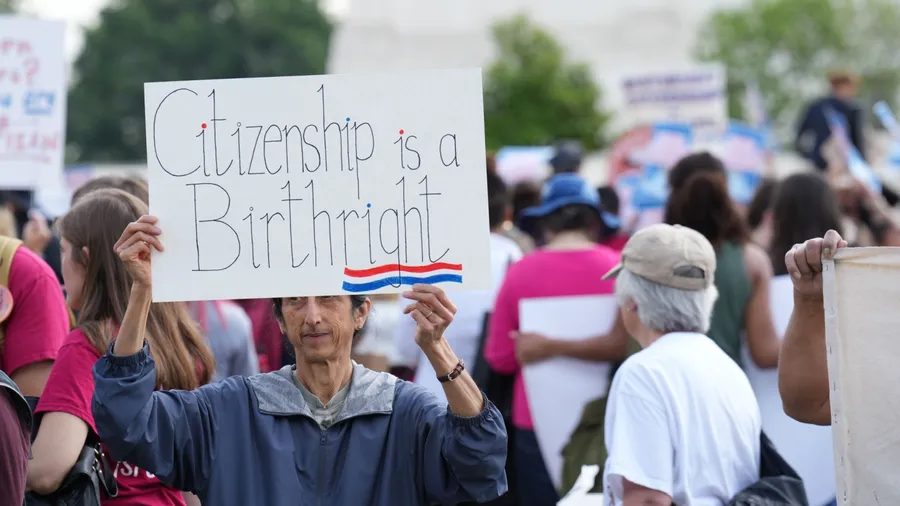 Washington, DC – May 15, 2025: Several hundred protesters rally at the Supreme Court against president Trump's illegal executive order to make birthright citizenship conditional.
