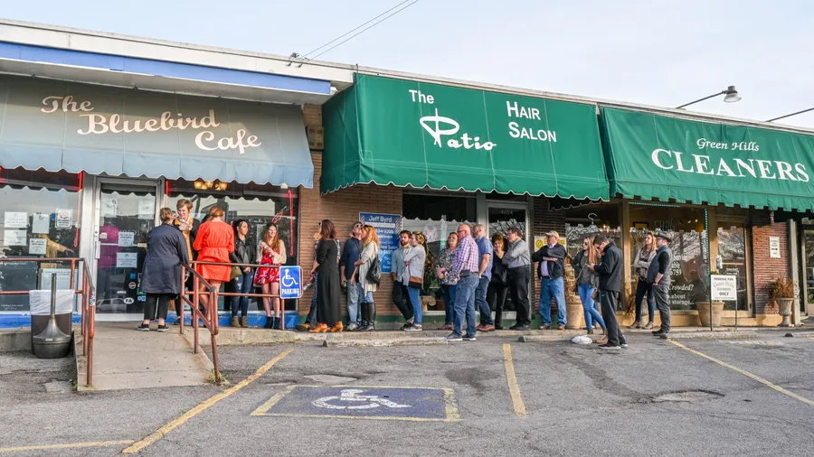 NASHVILLE, TN, USA - MARCH 24, 2019: People queue outside world famous Bluebird Cafe. This music club opened in 1982 and features acoustic music by its composers.