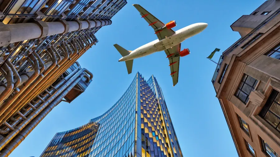 a jet plane flying over the city