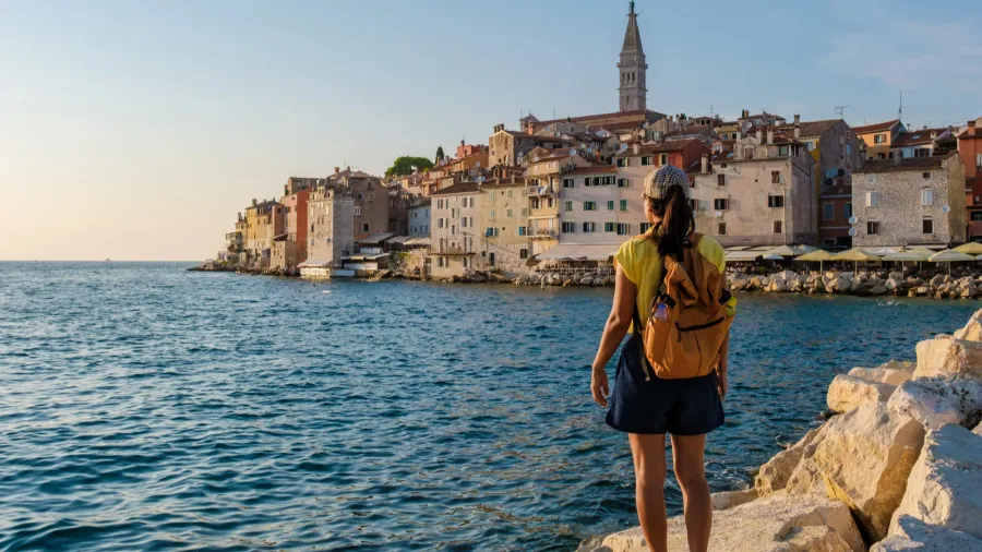 a traveler gazes at the picturesque town of rovinj croatia
