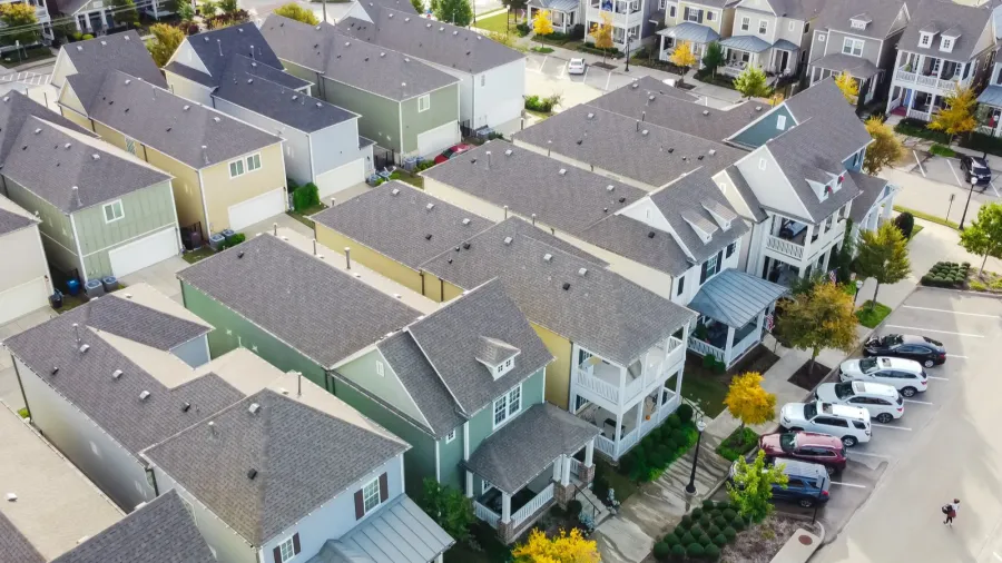 aerial view closeup roof shingles of new development townhouse near