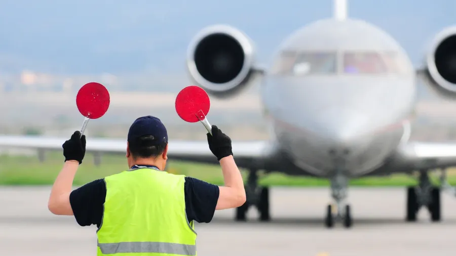 air traffic controller holding signs