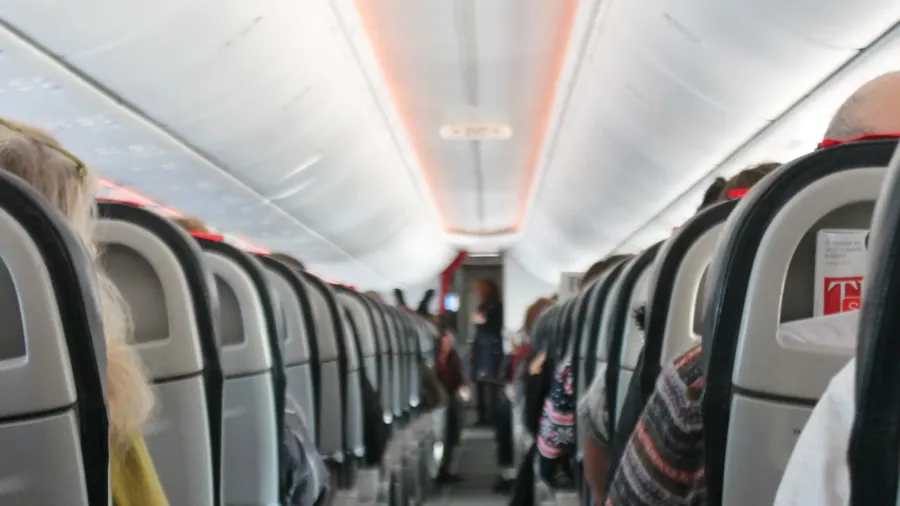 airplane cabin aisle with rear view and seats