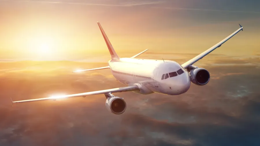 airplane in the sky at sunset