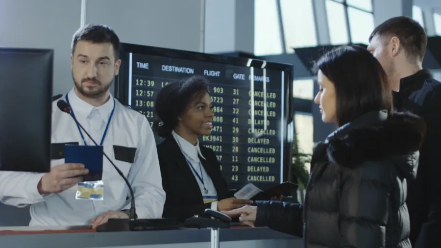airport workers checking documents at control point