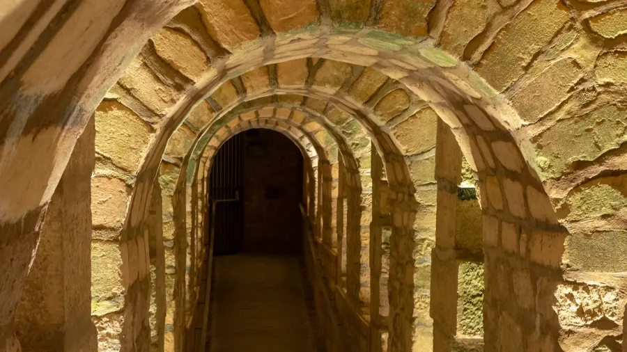 arched stone tunnel in the paris catacombs