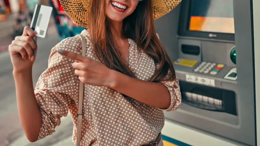 attractive girl tourist in sunglasses a blouse and a straw