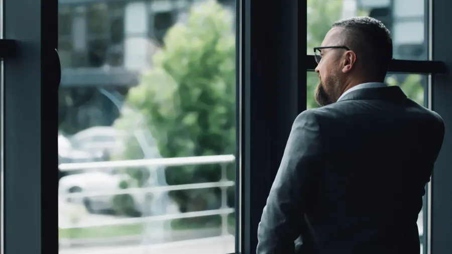 back view of businessman in formal wear talking on smartphone