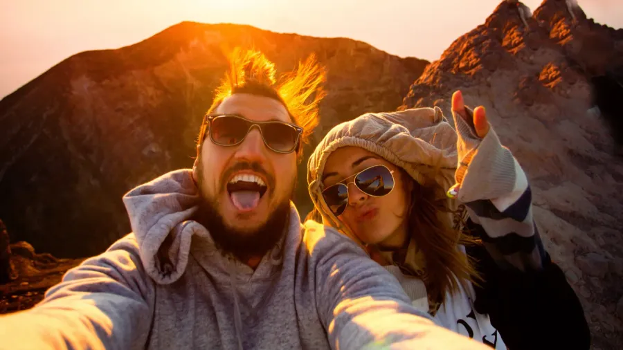 beautiful traveling couple on the top of the mountain