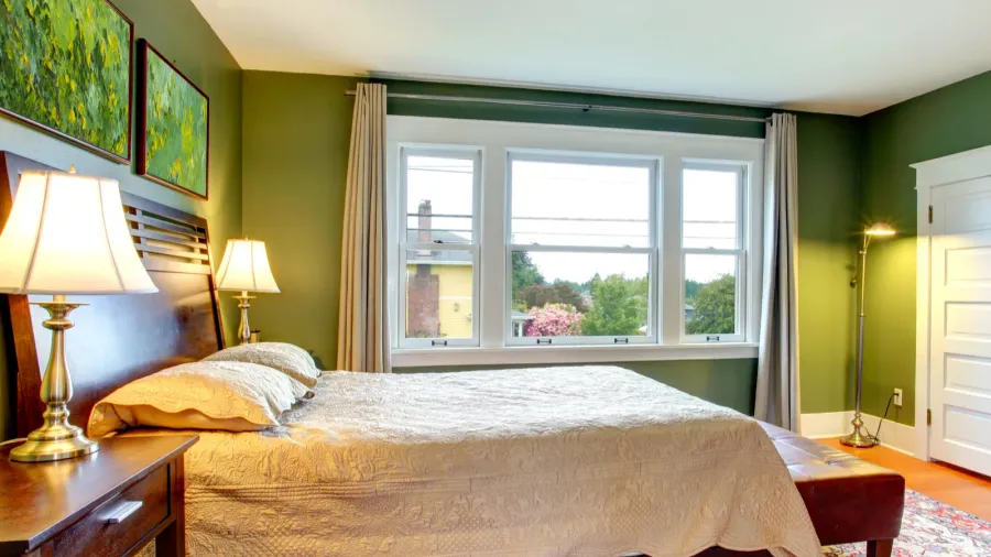 bedroom interior with green walls and soft lighting