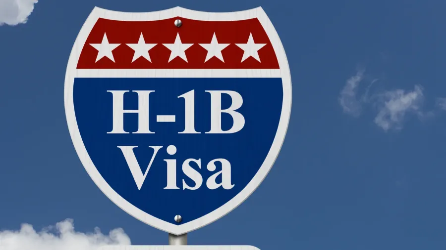 blue and red road sign displaying h1b visa with