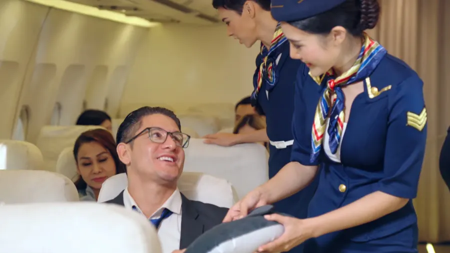cabin crew give service to passenger in airplane