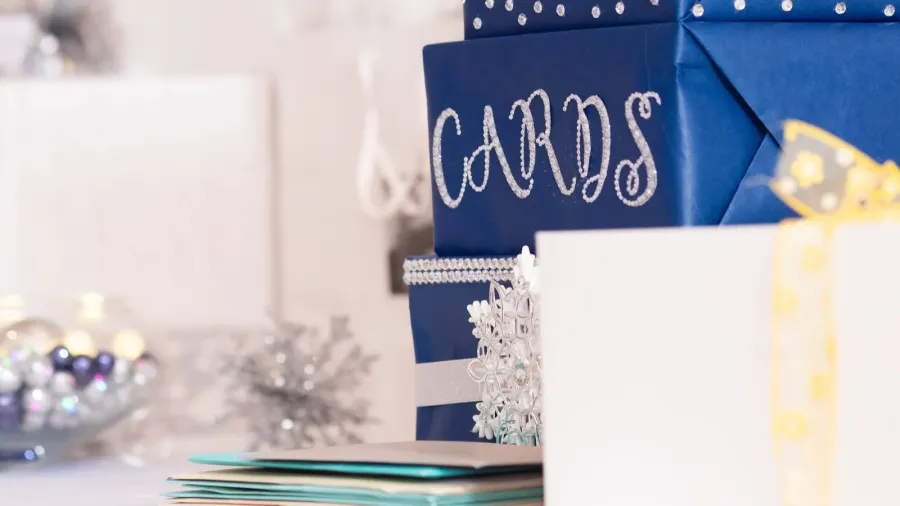 A gift table with wrapped gifts, cards, and decor accents on it.