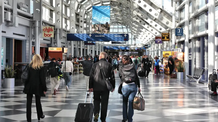 Travelers walk to gates at Chicago O'Hare International Airport in USA.