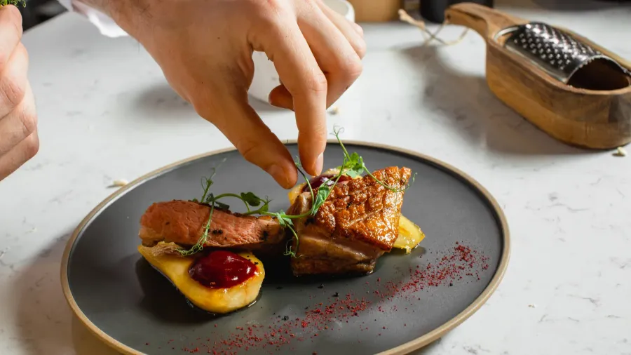 closeup photo of professional chefcook decorating dish