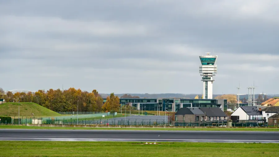 control tower at brussels airport zaventem rising above runways and
