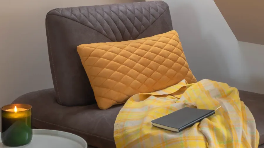 cozy nook by the window with yellow blanket and pillow