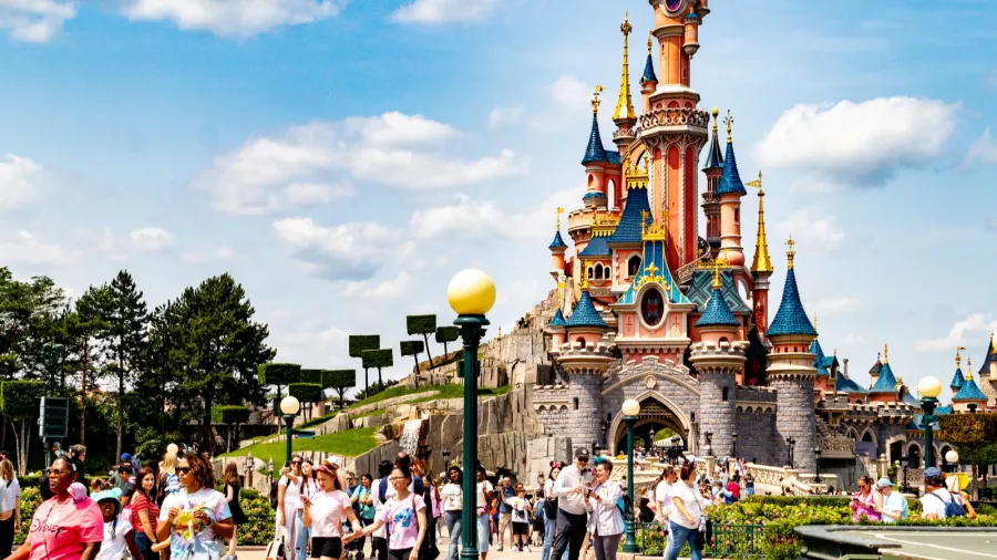 crowd of people in front of a fairytale castle under