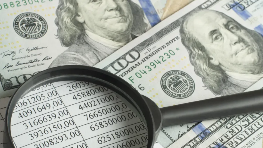 financial and budget concept magnifying glass money and financial document
