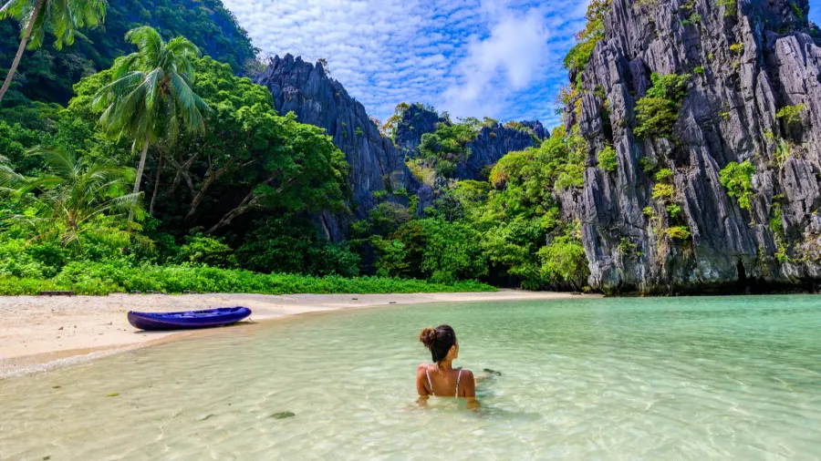 girl at hidden beach in matinloc island el nido palawan