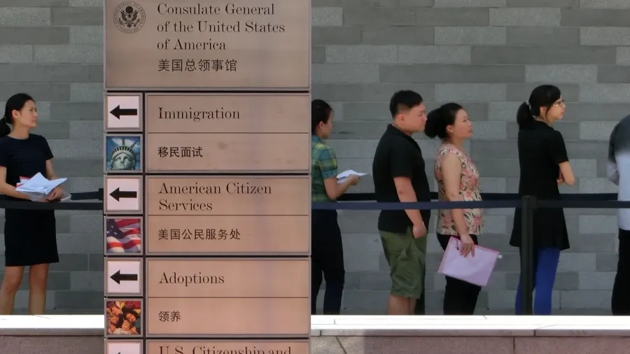 People standing in a queue in front of The Consulate General of United States, applying for USA Visas.
