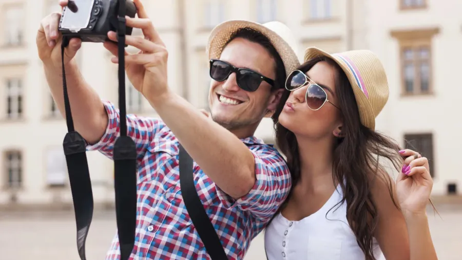 happy tourists taking photo of themselves