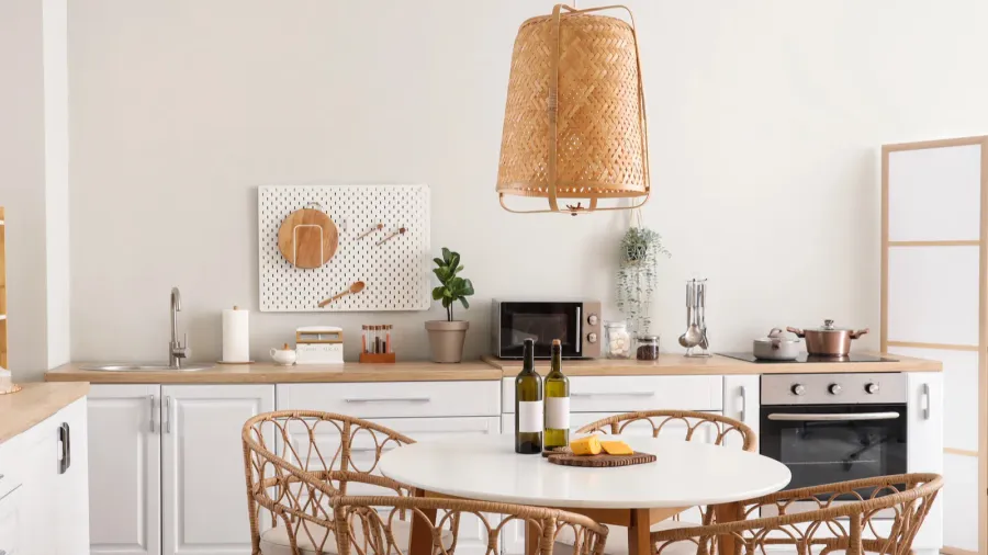 interior of beautiful kitchen with white counters dining table chairs