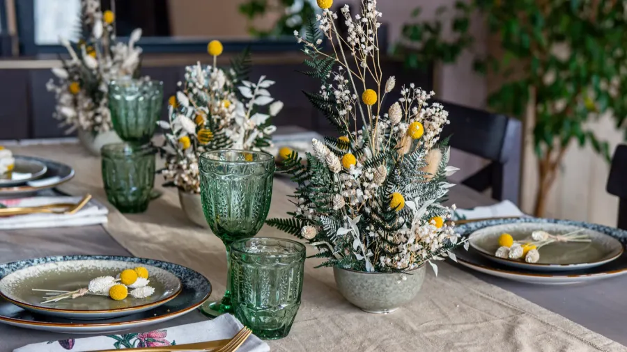 large kitchen table with thalers cutlery and glass glasses before