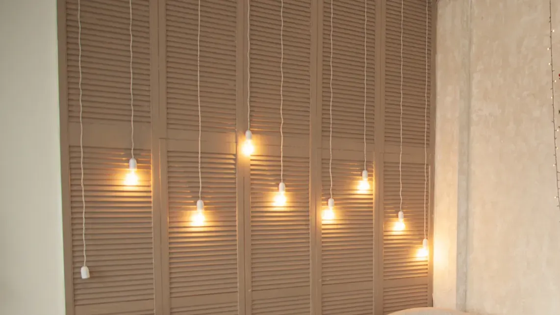 light bulbs hang on long wires on the background of