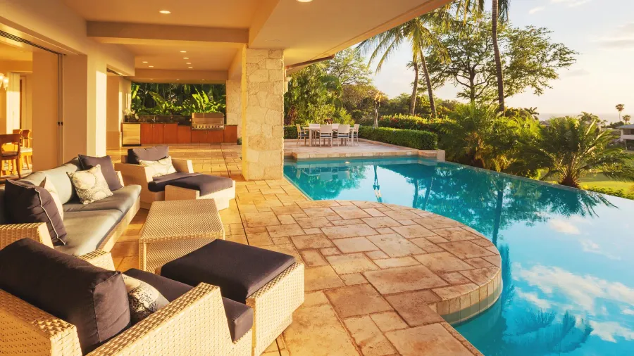 luxury home with pool at sunset