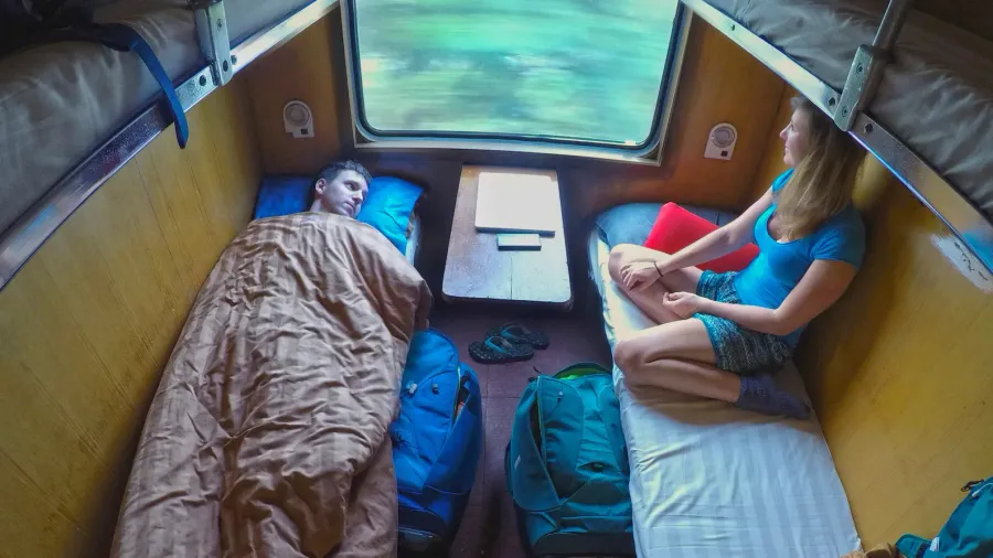 male and female backpackers resting while travelling in a cool