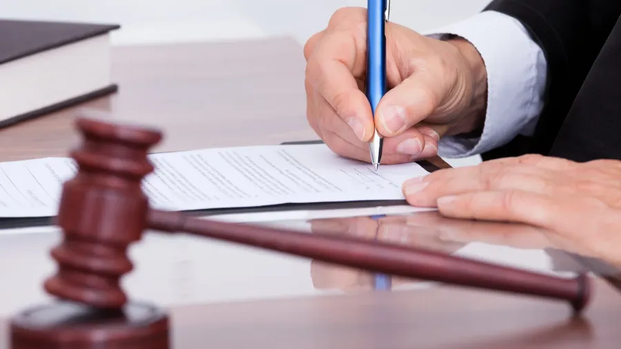 male judge writing on paper