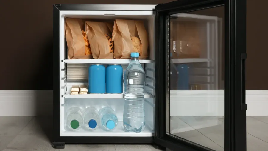 mini bar filled with food and drinks near brown wall